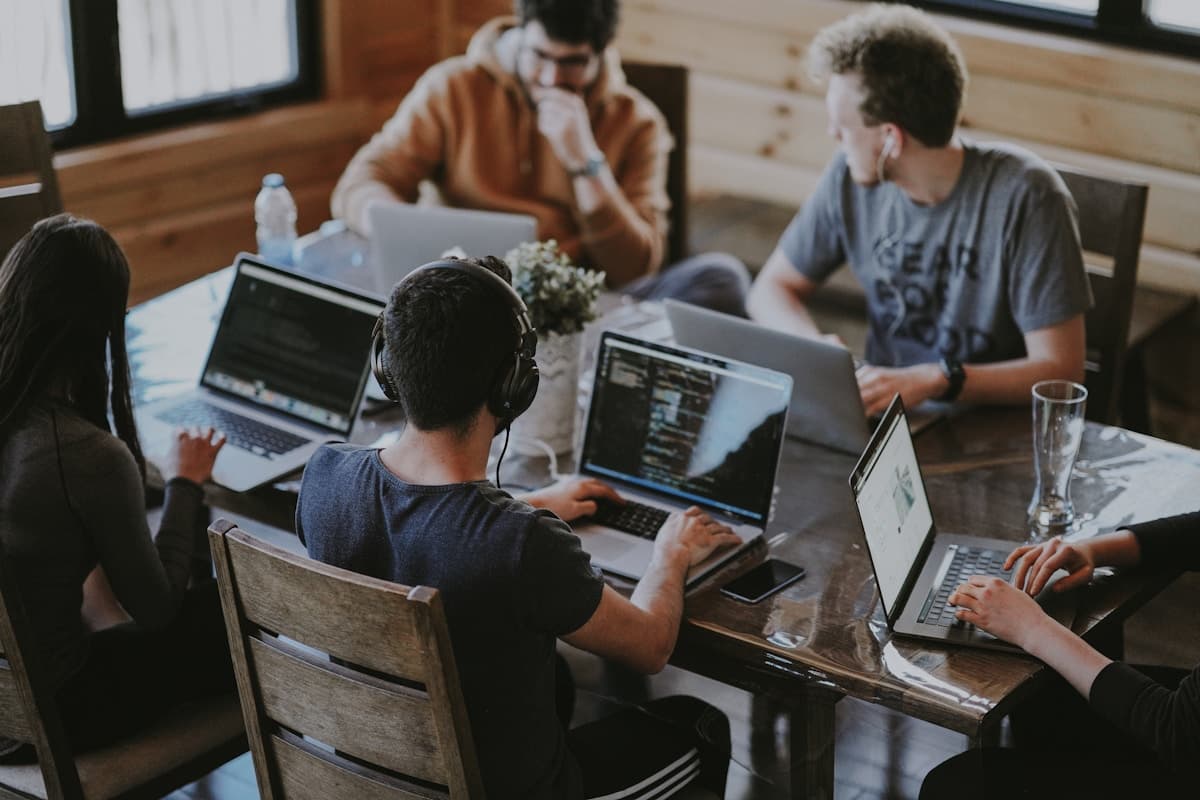 A diverse group of people from different professions using AI tools on various devices